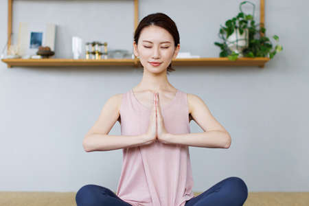 Young Asian woman practicing yogaの写真素材