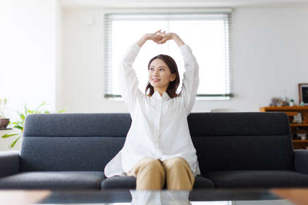 Young Asian woman stretching her armsの写真素材