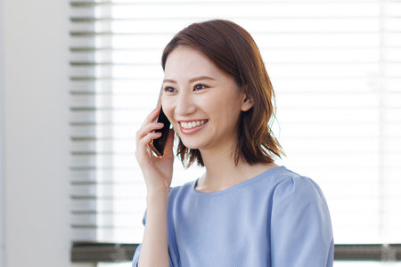 Young Asian woman having a phone callの写真素材