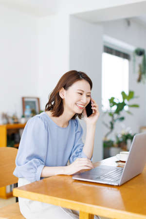 Young Asian woman having a phone callの写真素材