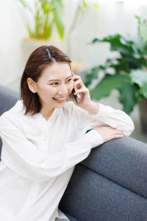 Young Asian woman having a phone callの写真素材