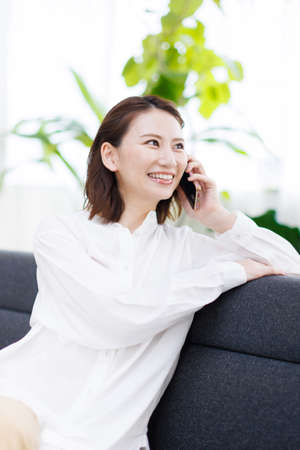 Young Asian woman having a phone callの写真素材