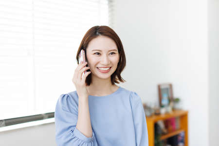 Young Asian woman having a phone callの写真素材
