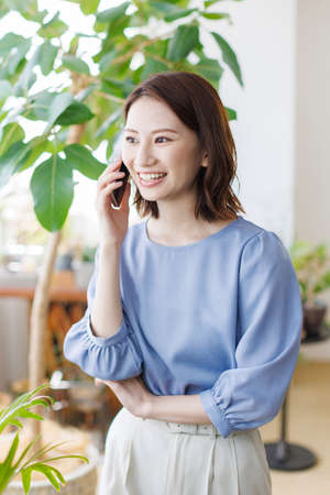 Young Asian woman having a phone callの写真素材