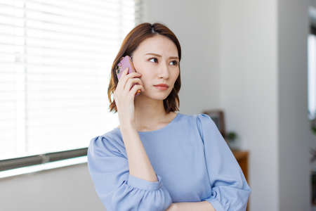 Young Asian woman having a phone callの写真素材