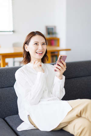 Young Asian woman using a mobile phoneの写真素材