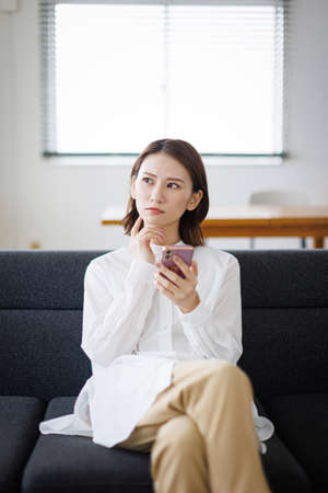 Young Asian woman using a mobile phoneの写真素材