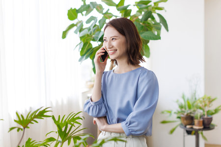 Young Asian woman having a phone callの写真素材