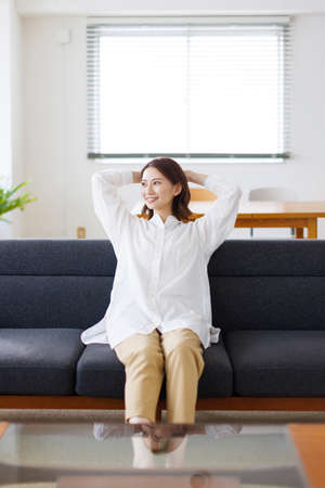 Young Asian woman relaxing at homeの写真素材