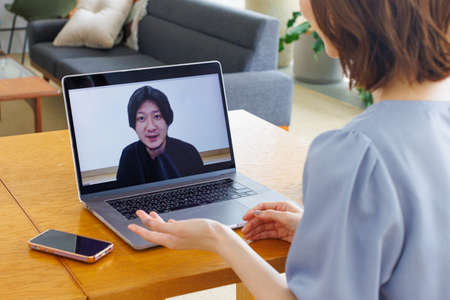 Young Asian woman having a video call on a laptop