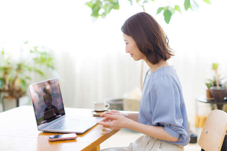 Young Asian woman having a video call on a laptop