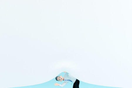 3D businessman waving hello from under white sheetの写真素材