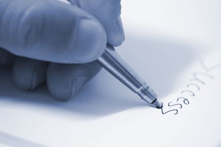 writing the success on the paper.の写真素材