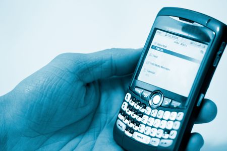 hand holding pda cell phone, concept of receiving emailの写真素材