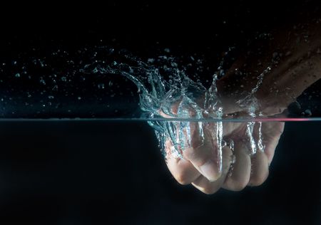 the hand dropped into water の写真素材