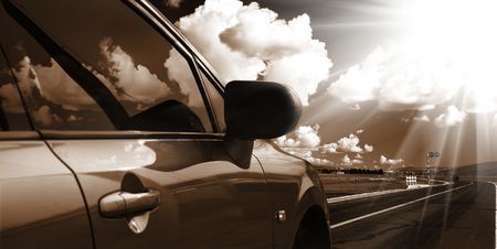 the car on the road with the background of meadow.の写真素材