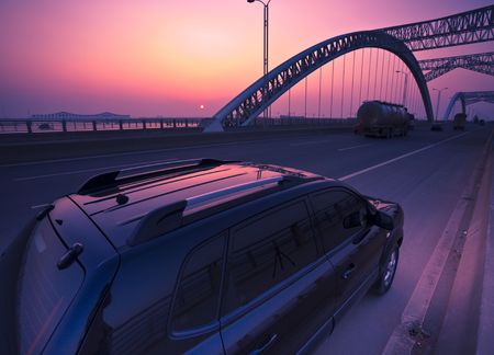 truck speeding through a bridge at sunset,motion blur.の写真素材