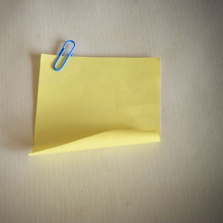 yellow notepaper on the yellow background indoor.の写真素材