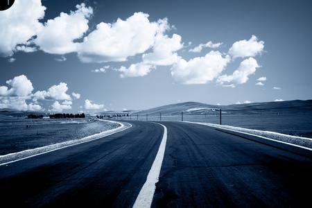 road to the future with the mountain and blue sky background outdoor.の写真素材