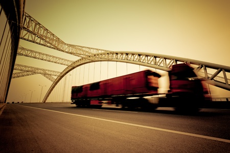 speeding truck go through the bridge.の写真素材