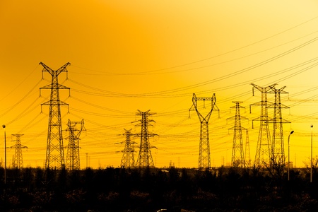 High voltage towers aganist the sunset background.