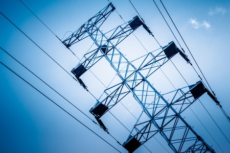 High voltage towers with sky background. blue toned image.の写真素材
