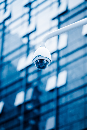 security camera in front of the office building,blue toned image.の写真素材