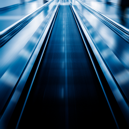 moving walkways at airport,blue toned image.の写真素材