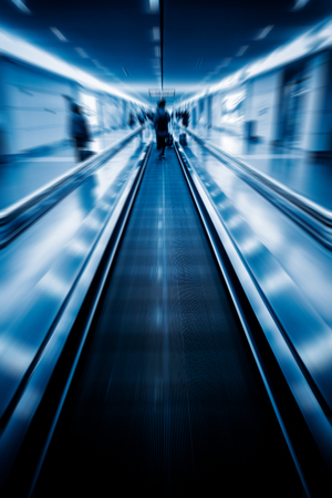 moving walkways at airport,blue toned image.の写真素材