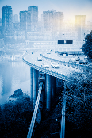 traffic on highway,with city skyline background,chongqing china.の写真素材