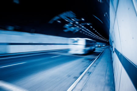 traffic in tunnel,chongqing china,blue toned image.の写真素材