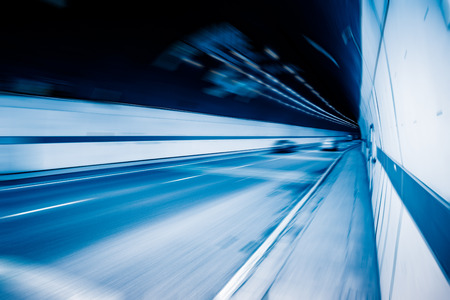 traffic in tunnel,chongqing china,blue toned image.の写真素材