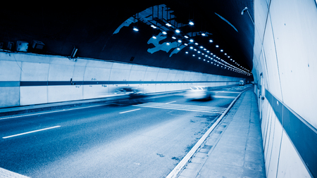 traffic in tunnel,chongqing china,blue toned image.の写真素材