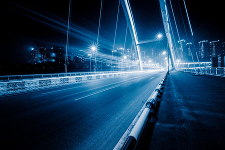 traffic trails on bridge,chongqing china,blue toned image.の写真素材
