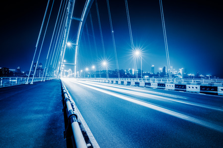 traffic trails at caiyuanba yangtze river bridge,chongqing china.の写真素材