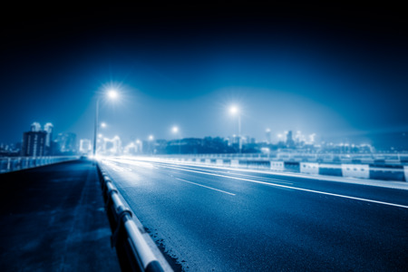 traffic trails on bridge,chongqing china,blue toned image.の写真素材