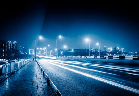 traffic trails on bridge,chongqing china,blue toned image.の写真素材