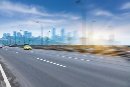 motion traffic on highway wity city background, chongqing china.の写真素材