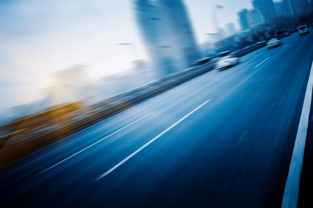 motion traffic on highway wity city background, chongqing china.の写真素材