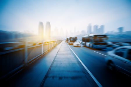 motion traffic on highway with city background, chongqing china.の写真素材