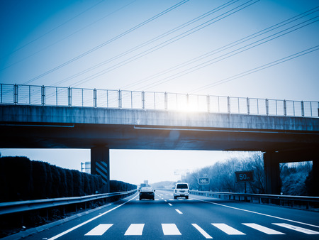 car driving on the highway,blue toned image.の写真素材