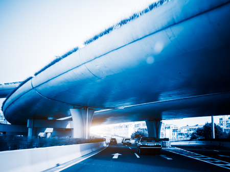 car driving under the overpass,blue toned image.の写真素材
