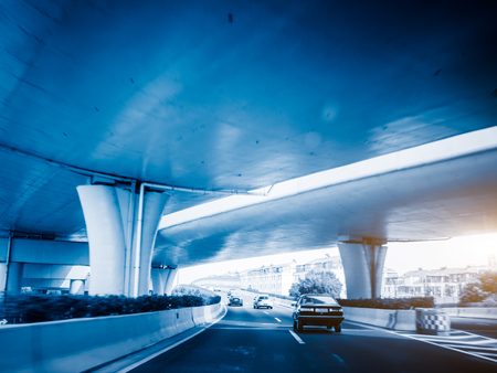 car driving under the overpass,blue toned image.の写真素材