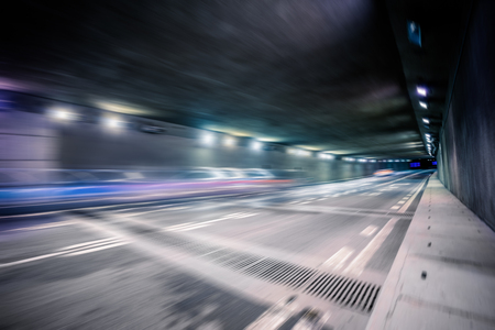 motion blurred car in tunnel.Chinese characters on road are all traffic roadmarking.の写真素材