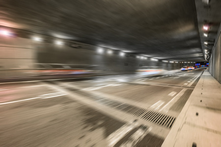 motion blurred car in tunnel.Chinese characters on road are all traffic roadmarking.の写真素材