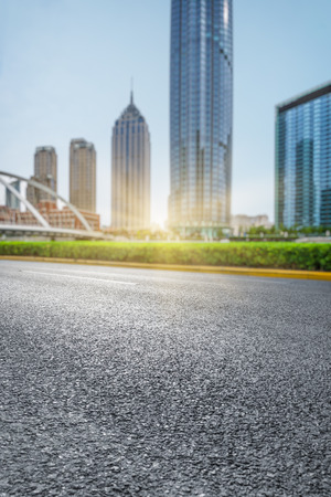 clean asphalt road with city skyline background,china.の写真素材