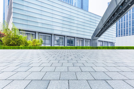 empty pavement and modern buildings in cityの写真素材
