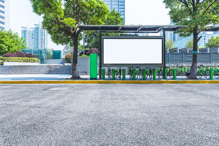 clean road with bus stop and modern buildings backgroundの写真素材