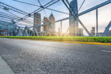 clean asphalt road with city skyline background,china.の写真素材
