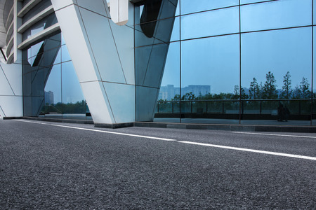 city empty traffic road with cityscape in backgroundの写真素材